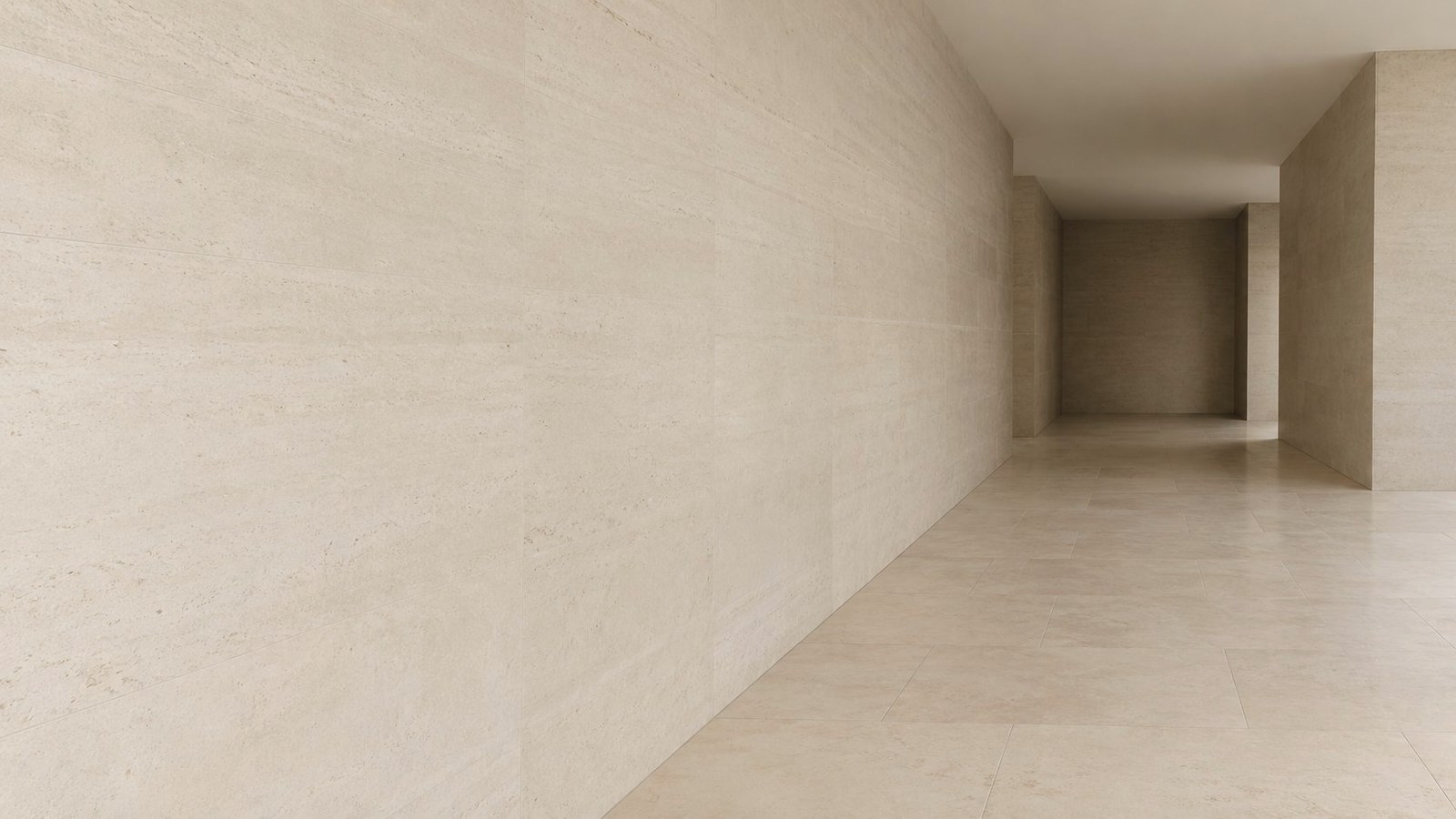 A travertine corridor leading to an illuminated opening